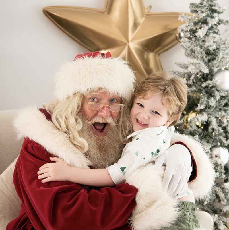 young boy hugging santa